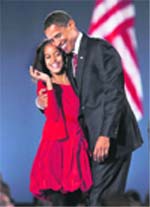 Obama celebrates with his daughter Malia at the election night rally in Chicago