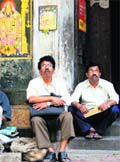 Investors watch share prices on a digital stock ticker outside the Bombay Stock Exchange building in Mumbai 