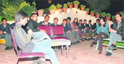 A student recites a poem at the poetry reading session of a creative writing venture.