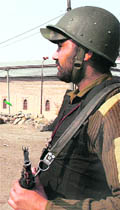       Jawan stands guard near the historic Jamia Masjid in Srinagar on Thursday. 