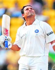 Sachin Tendulkar celebrates after scoring a century on the first day of the fourth Test against Australia in Nagpur