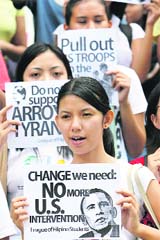University students hold a rally calling for U.S. President-elect Barack Obama's removal of U.S. troops from the Philippines in Manila on Thursday