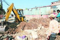 An anti-encroachment drive in progress at Industrial Area, Chandigarh, on Friday.