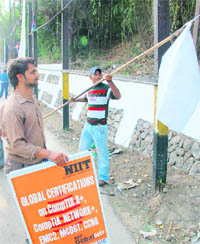 Municipal staff remove banners and hoardings in Jammu.