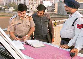 Zirakpur traffic in-charge Sanjeev Kumar challans a vehicle on Friday evening at Zirakpur