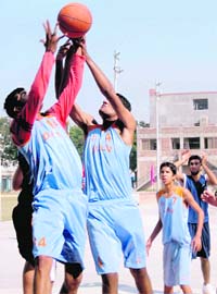 DAV SSS-8 boys (in sky blue) avoid a GNPS player in the Rao Jai Singh (for boys) and Shant H Singh (for girls) Memorial Basketball Tournament