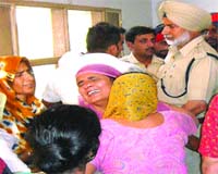 Irate relatives of NRI Sarabjit Singh moan his death in front of the operation theatre of the civil hospital in Nawanshahr