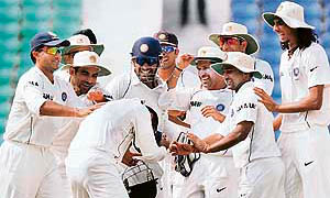 The Indian team celebrates after the dismissal of Australia's Michael Hussey on the third day of the fourth Test in Nagpur on Saturday.