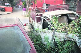 Vehicles lie abandoned in front of the Industrial Area police station