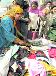 As mercury dips in the valley, people purchase woollens in Srinagar, on Sunday.