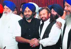Punjabi singer Hans Raj Hans with SAD president Sukhbir Badal after joining the party in Jalandhar