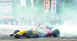 ING Renaults F1 car performs during a roadshow at Rajpath in New Delhi on Sunday. The Renault team is on a worldwide multi-city tour.