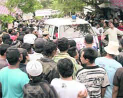 Indonesian hardliner Muslims surround an ambulance that carries the bodies of two of the Bali bombers as it travels to a cemetery at Tenggulun village near Lamongan, East Java province, on Sunday.