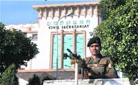 A paramilitary soldier stands guard outside the civil secretariat building in Jammu on Monday. 