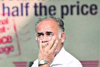 An investor reacts as he watches share prices on the broadcast screen of the Bombay Stock Exchange in Mumbai