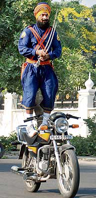 A devotee performs at a procession to mark Gurpurb celebrations in Mohali on Tuesday. 