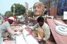 Labourers give final touches to the pavilion of Delhi for the upcoming India International Trade Fair 2008 at Pragati Maidan in New Delhi