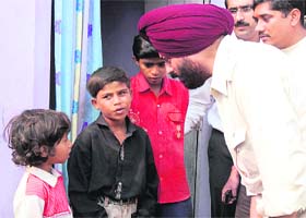 M.S. Bitta, chairman of the All-India Anti-Terorist Front, visits a Marathi family in Karnal