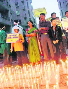 People stage a protest in Gurgaon on Tuesday against the alleged torture of a maid servant