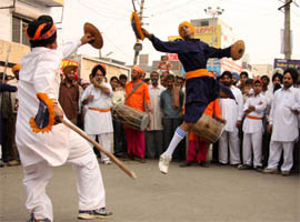 Sikh youths performing gatka during the nagar kirtan organised on the eve of birth anniversary of Guru Nanak Dev in Bathinda on Wednesday.