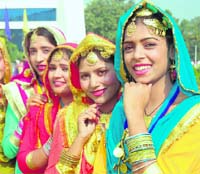 Girls wait for their turn on the inaugural day of the three-day Punjabi University 