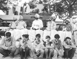 Poppy husk smuggling accused sit beside the contraband in Rajpura 
