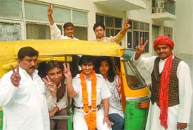 Delhi Pradesh National Panthers Party candidate Sunita Chaudhary, the first woman autorickshaw driver in the city with other candidates takes a ride in her autorickshaw after a press conference in New Delhi