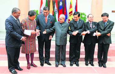 FOREIGN MINISTERS HAND-IN-HAND: (From left) Nepals Upendra Yadav, Bhutan's Khandu Wangchuk, Sri Lanka's Rohitha Bogollagama, India's Pranab Mukherjee, Myanmars Nyan Win, Bangladesh's Iftekhar Ahmed Choudhury and Thailand's Sukhumpong Ngonkam shake hands as they pose for the media prior to a meeting of foreign ministers in New Delhi on Wednesday. Heads of state and ministers from these countries are in India to take part in the Second Summit of the Bay of Bengal Initiative for Multi-Sectoral Technical and  Economic Cooperation to be held in New Delhi on Thursday