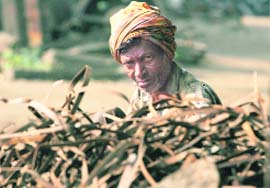 A worker at a steel rolling mill in Mandi Gobindgarh watches through a pile of iron scrap. The factory stopped production last week. 