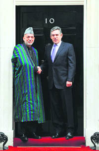 Britains Prime Minister Gordon Brown meets Afganistan President Hamid Karzai at Downing Street in London on Thursday.