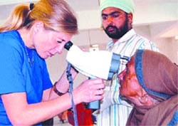 A foreign doctor examines a patient during an eye camp in Amritsar