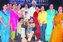 Jubilant students and teachers of the SR Government College for Women receive the zonal youth festival winners trophy in Amritsar.