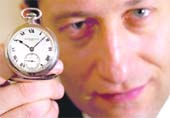 Aurel Bacs, company head of the International Watch at Christie's auction house, holds a platinum Patek Philippe tourbillon watch ref. no 198'311 during a photo call in Geneva on Friday. The watch, made specially for Henry Graves Jr in 1932 is expected to fetch between $500,000 and 10,00,000 at the sale in Geneva on November 17.  Reuters