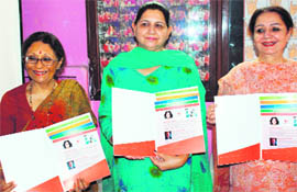 Adity Dua, wife of H. K. Dua, Editor-in-Chief, The Tribune (left), releases an e-book on dental hygiene in Chandigarh on Friday.
