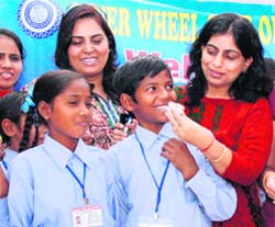 Members of Inner Wheel Club celebrate Children's Day with students of the National Child Labour Project School at Moti Nagar in Ludhiana