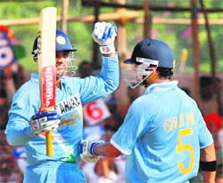 Virender Sehwag reacts after completing his half century during the first one-dayer in Rajkot on Friday. 