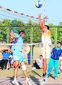 A player smashes the ball during the Panjab University Inter-College Volleyball quarterfinal match between PU Campus and DM College, Moga, at PU grounds on Saturday.