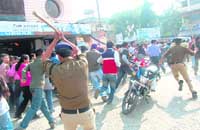 Cops disperse a mob outside Natraj Cinema in Dehradun on Monday. 