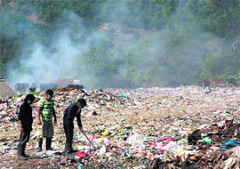 Smoke rising from burnt plastic waste at the solid waste management site of the Dharamsala municipal council.