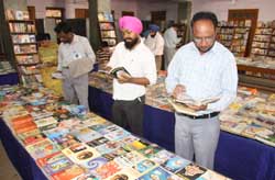 Book lovers take their pick at the exhibition held at the Public Library in Bathinda on Sunday. The exhibition will be on till November 22. 