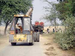 Vehicles carrying rail lines and fish plates near Abohar. 