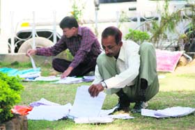 Polling staff check voters list in the DC office at Jammu
