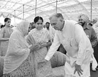 MP Governor Balram Jakhar seeks blessings of Bibi Harbaksh Kaur Hayer at a function.