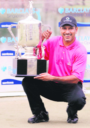 Jeev Milkha Singh displays the trophy after winning the Singapore Open Barclays golf tournament on Sunday.
