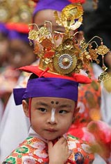 A girl dressed in traditional attire takes part in a march at Sensoji temple as part of the 24th General Conference of World Fellowships of Buddhists in Tokyo on Sunday.