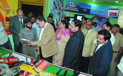 The finance minister of Haryana, Birender Singh, looks at sports products at the Haryana pavilion during the IITF-2008 at Pragati Maidan in New Delhi on Monday