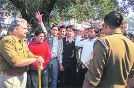 Students protest at the Clock Tower in Dehradun on Monday. 