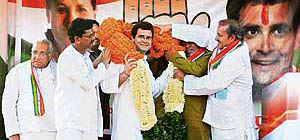 Congress general secretary Rahul Gandhi is garlanded by Chhattisgarh leaders during an election rally in Raipur on Monday.