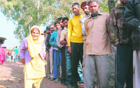 An ecstatic elederly woman on the way to casting her vote in Poonch.