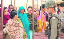 Women queue up for their turn to vote at a polling booth in Poonch on Monday.